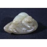 CHINESE PENDANT, possibly mutton fat jade, carved as a leopard on a rock, length 3.8cm