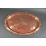 HUGH WALLIS - ARTS & CRAFTS TRAY a large copper oval tray, hand beaten in the centre and the rim