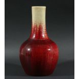 CHINESE SANG DE BOEUF VASE, of mallet form, with a mottled oatmeal to red glaze, height 29.5cm