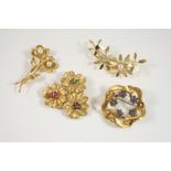 AN 18CT. GOLD TRIPLE FLOWERHEAD BROOCH each centred with a circular-cut diamond (one missing) within