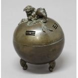 BRONZE CENSER, of spherical form with temple dog finial and on three scrolling legs, height 18cm