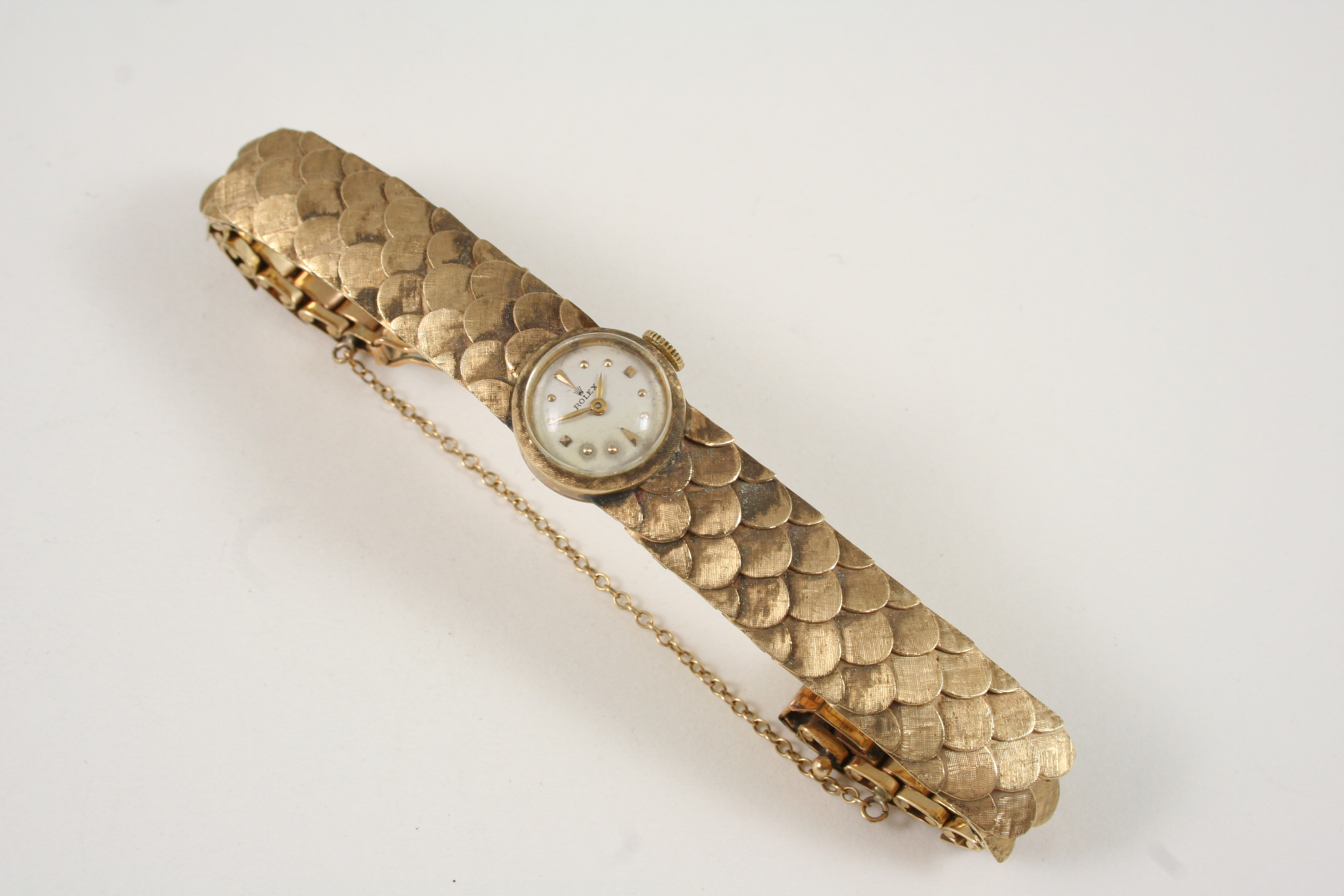 A LADY'S 14CT. GOLD WRISTWATCH BY ROLEX the signed circular dial with dagger and dot numerals, on an