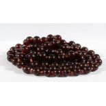 CHINESE STRING OF 108 AMBER BEADS, natural cherry colour averaging 11.5mm diameter and weighing 92