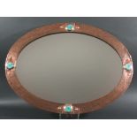 ARTS & CRAFTS MIRROR a copper Arts and Crafts oval mirror, set with 4 Ruskin style roundels and with