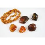 FOUR SPECIMENS OF BALTIC AMBER total weight 178 grams, together with an amber necklace, 73 grams.