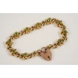 A 15CT. GOLD AND PERIDOT CURB LINK BRACELET the fancy curb link bracelet is set with ten circular-