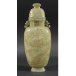 CHINESE LIGHT GREEN JADE VASE AND COVER, carved with scrolling dragons beneath a pair of handles,