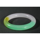 CHINESE JADE TYPE BANGLE, in tones of green, yellow and mauve, diameter 8.5cm