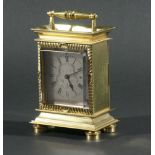 BRASS CARRIAGE CLOCK, the silvered dial with engraved scrolling decoration on a Swiss eight day