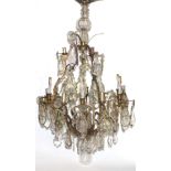 LARGE FRENCH TWENTY LIGHT BRASS AND CUT GLASS CHANDELIER, the two tiers of scrolling branches with