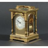 FRENCH BRASS FOUR PANE CARRIAGE CLOCK, the silvered dial with engine turned centre in an arched gilt