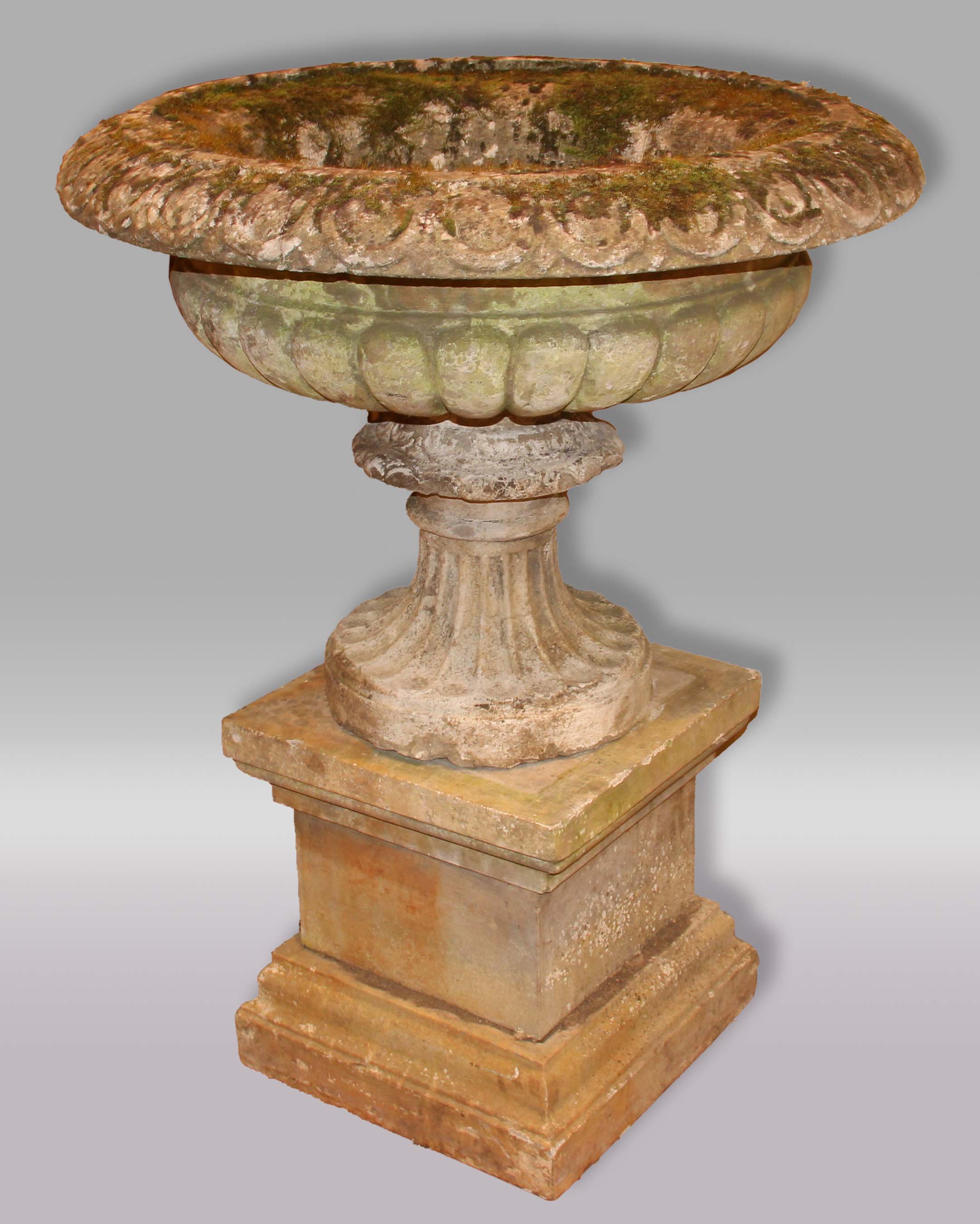 RECONSTITUTED STONE URN ON PEDESTAL, with egg and dart rim, stop fluted body, scalloped foot and