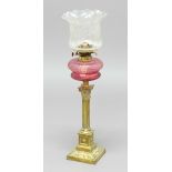 VICTORIAN OIL LAMP, the etched glass shade above a cranberry glass reservoir and brass corinthian