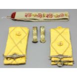 PAIR OF YELLOW SILK TIE BACKS, with beaded flower head and rope decoration; a pair of brass tie