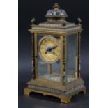 FRENCH BRASS AND CHAMPLEVE FOUR PANE MANTEL CLOCK, the 4 1/4" dial with a clear paste mounted frame,