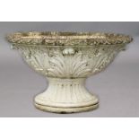OVAL RECONSTITUTED STONE URN, with stiff leaf rim, foliate body and fluted socle base, length 100cm