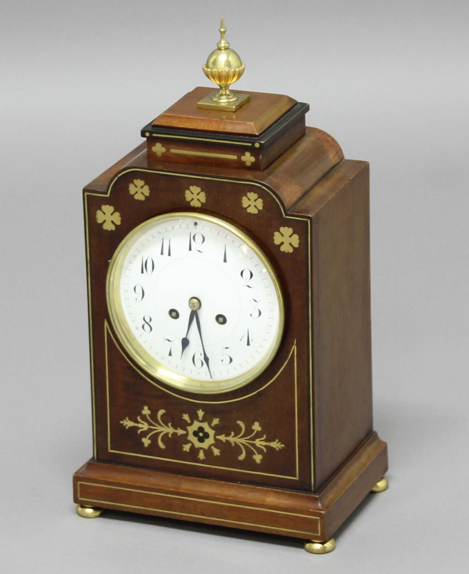 REGENCY STYLE MAHOGANY AND BRASS MOUNTED MANTEL CLOCK, the 5 1/2" enamelled dial with arabic