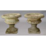 PAIR OF RECONSTITUTED STONE SHALLOW URNS, stop fluted decoration on socle bases, diameter 54cm (2)