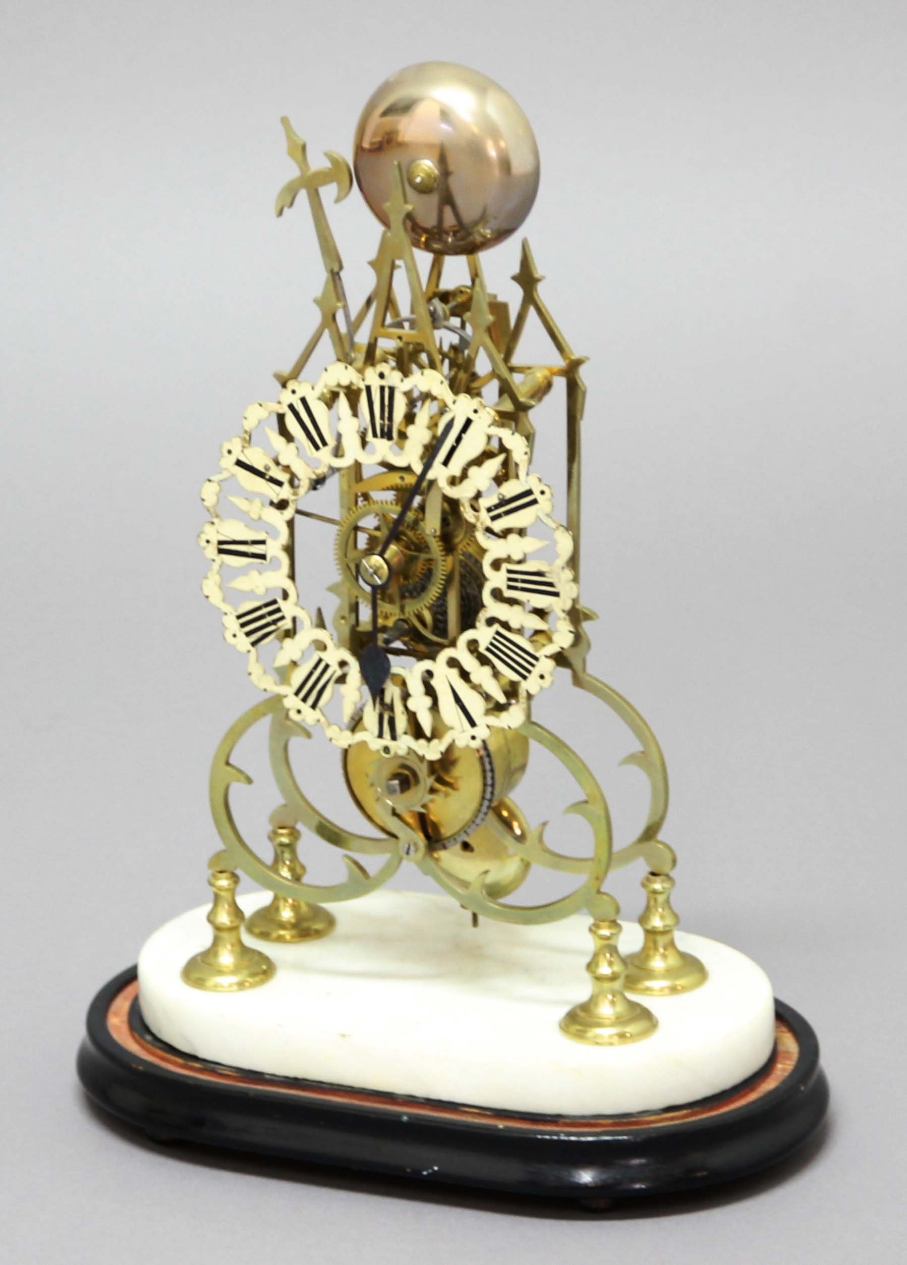 BRASS CATHEDRAL SKELETON CLOCK, the 6" gothic pierced dial on a brass single fusee movement striking