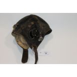 A C TYPE PERIOD FLYING HELMET & TUNIC. A WW11 'C' type flying helmet, with bacolite ear pieces inset
