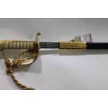 A NAVAL OFFICERS SWORD. A QE11 period Naval Officers Sword complete with scabbard/swordknot and