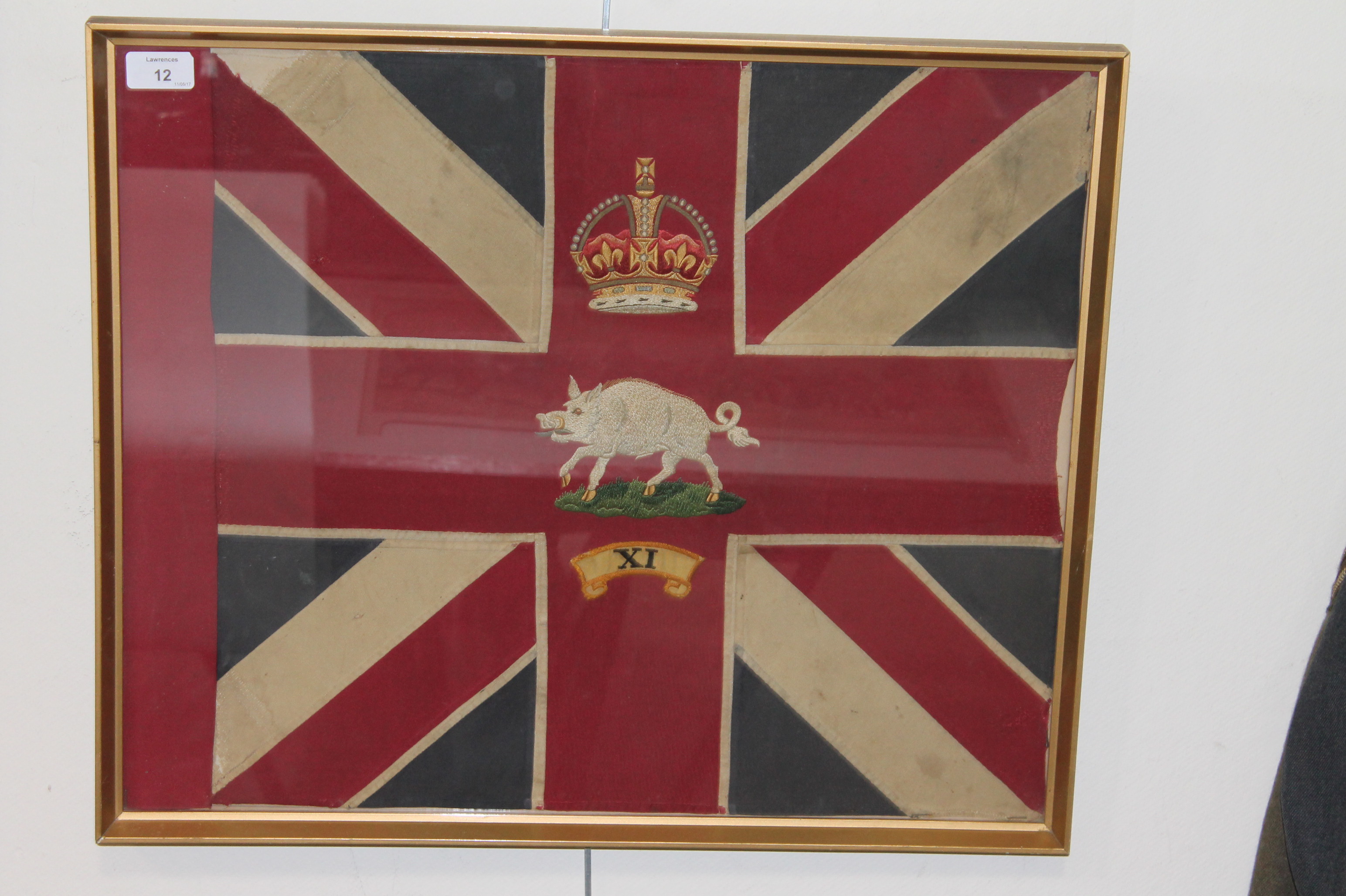 A FRAMED REGIMENTAL FLAG. Set in a partial Union Jack the Kings Crown above a Charging Boar, with X1