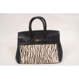 A BLACK LEATHER AND ZEBRA 'HERMES' BAG Inner side pocket with zip. Open side pocket. Closing flap