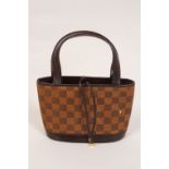 A LOUIS VUITTON HANDBAG Fur checkered bucket bag with handles and fastening leather laces with LV