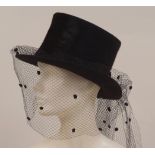 A 1980'S 'JOHN BOYD' LADIES TOP HAT A black ladies silk and felt top hat with lace veil. Labelled '