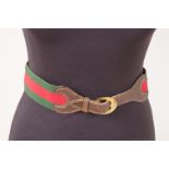 A 'GUCCI' BELT Green and red fabric with horse bit on leather in centre. Horse shoe gold buckle.