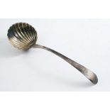 A GEORGE III IRISH SAUCE LADLE with a wrythen-fluted bowl and bright-cut borders around the stem,