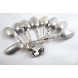 NINE VARIOUS ANTIQUE TABLE SPOONS:- A set of three Hanoverian fancy-backs (scallop shell),