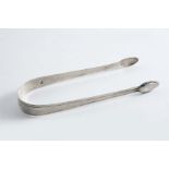 A PAIR OF LATE 18TH CENTURY SUGAR TONGS with intermittent feather-edging, initialled "J.M.P"