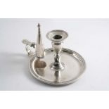 A GEORGE III CIRCULAR CHAMBERSTICK with detachable nozzle and later conical snuffer, crested, by