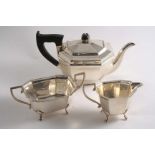 A MID 20TH CENTURY THREE-PIECE TEA SET with panelled bodies, angular handles and paw feet, by E.