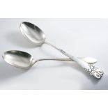 AN EARLY 20TH CENTURY DANISH LARGE SERVING SPOON with a hammered finish & cloud-like scrolls in