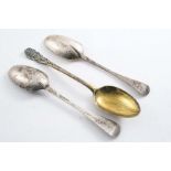 A GEORGE III SCOTTISH SILVERGILT TABLE SPOON with a rocaille, bearded mask terminal by P. Robertson,