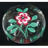 FRENCH FLORAL PAPERWEIGHT, probably 19th century, the six petal flowerhead with green leaves, with a