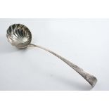 AN EARLY GEORGE III IRISH SOUP LADLE with a chased & fluted circular bowl and chased decoration up
