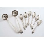 A SET OF SIX EARLY 20TH CENTURY CAST TEA SPOONS with mask terminals & fluted bowls, maker's mark "