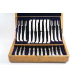 A LATE VICTORIAN CASED SET OF TWELVE PAIRS OF DESSERT/FRUIT KNIVES & FORKS with pistol handles,