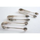 THREE PAIRS OF SCOTTISH SUGAR TONGS:- A provincial pair with fluted bowls, crested, by Robert Keay