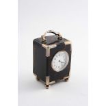 A LATE VICTORIAN MOUNTED TORTOISESHELL CARRIAGE TIMEPIECE with a swing handle, bun feet and a