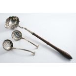 A GEORGE II TODDY LADLE with a turned wooden handle with a single-lipped, shaped oval bowl, crested,