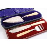 A CASED PAIR OF EARLY 20TH CENTURY FISH SERVERS with engraved detail & ivory handles, by the