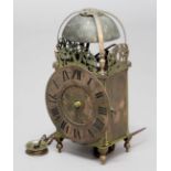 BRASS LANTERN CLOCK, the 6 1/2" dial on a brass movement striking to a bell, in a brass four