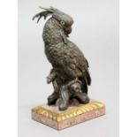 20th CENTURY SCHOOL, Parrot on a branch, bronze with glass eyes on a pink granite base with gilt