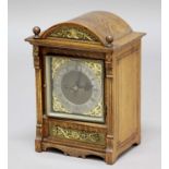 OAK CASED MANTEL CLOCK, the brass dial with 5 1/2" silvered chapter ring, on a brass eight day