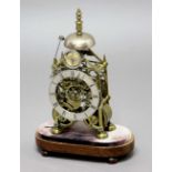 BRASS SKELETON CLOCK, the 5" silvered chapter ring beneath a strike silent dial, on a brass,