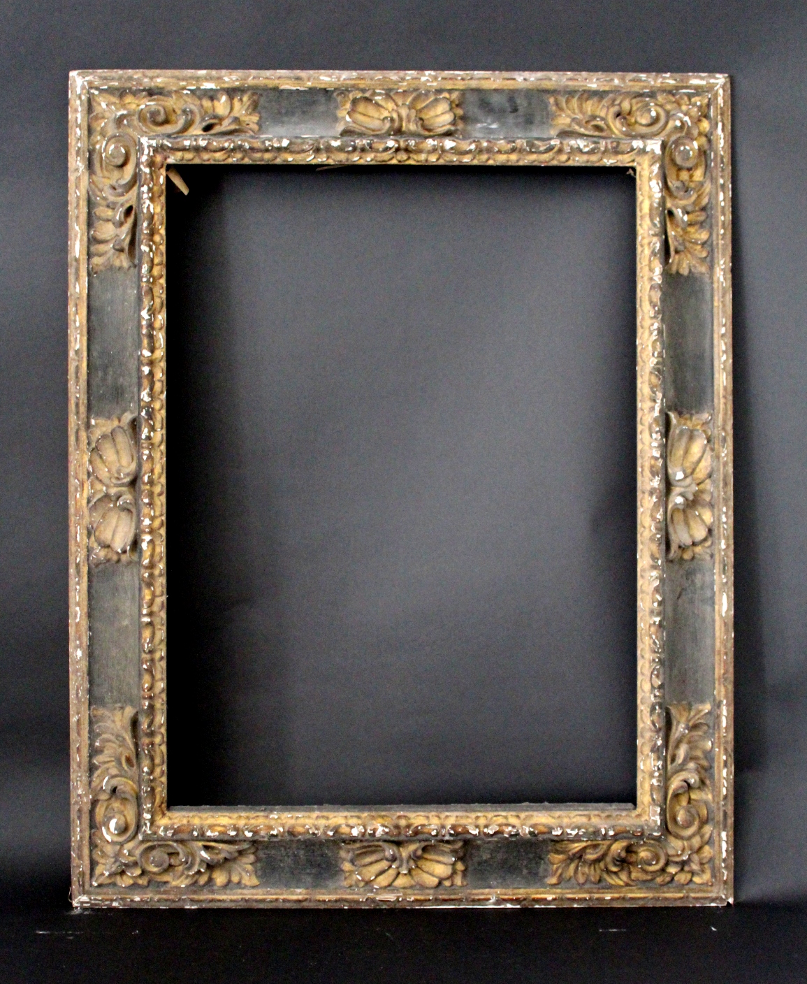 A PICTURE FRAME 19/20th Century, in Spanish Baroque style, carved wood, with gilt leafy scroll